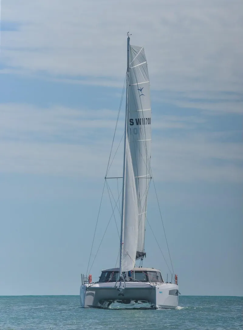 Slide: The Image of 2025 Seawind 1170 catamaran sailing on calm ocean under clear sky. - 40