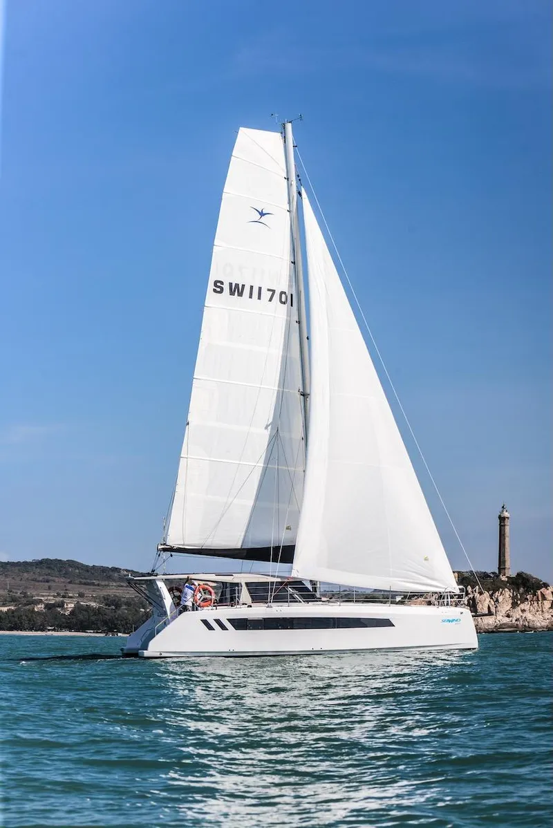 Slide: The Image of 2025 Seawind 1170 catamaran sailing on calm waters under clear blue skies. - 41