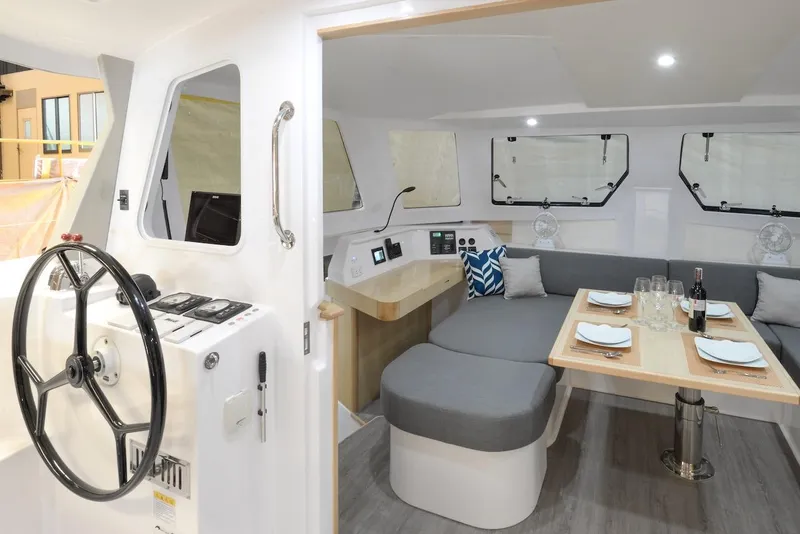 Slide: The Image of 2025 Seawind 1170 interior with modern dining area and helm station. - 45