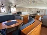 Slide: The Image of Interior of 2005 Lagoon 410 catamaran with dining area and kitchen. - 12
