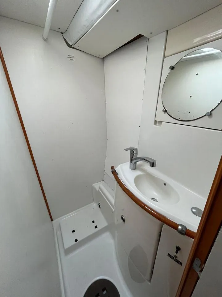 Slide: The Image of Compact bathroom in a 2005 Lagoon 410 catamaran with sink and mirror. - 20