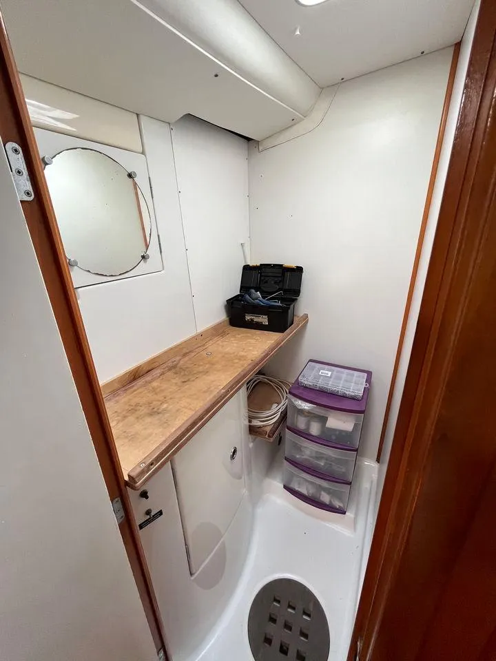 Slide: The Image of Lagoon 410 2005 model boat interior storage area with wooden countertop and plastic drawers. - 21