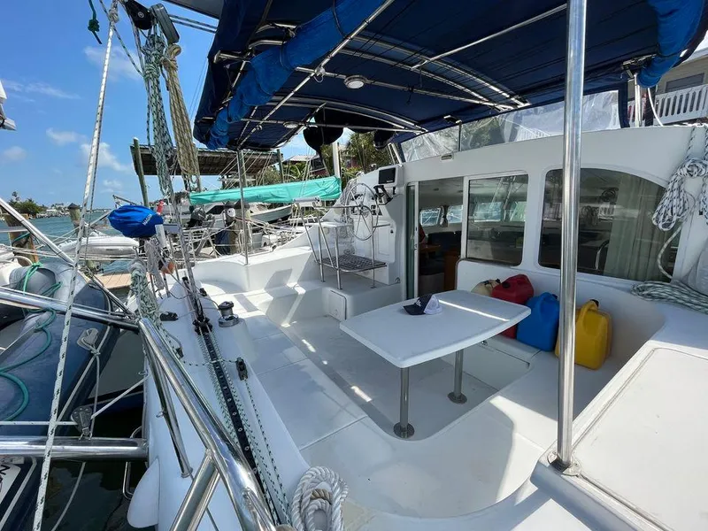 Slide: The Image of Lagoon 410 2005 catamaran deck with seating area and canopy. - 7