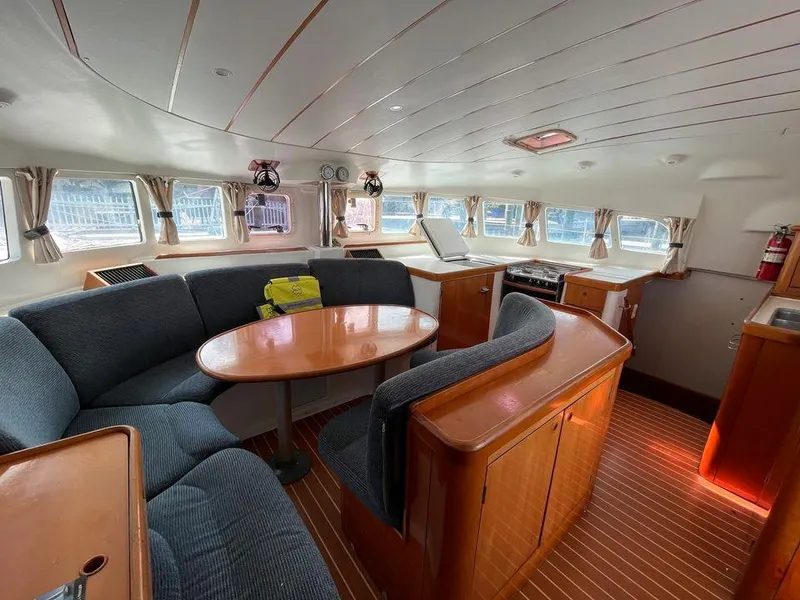 Slide: The Image of Interior of 2005 Lagoon 410 catamaran with dining area and kitchen. - 9