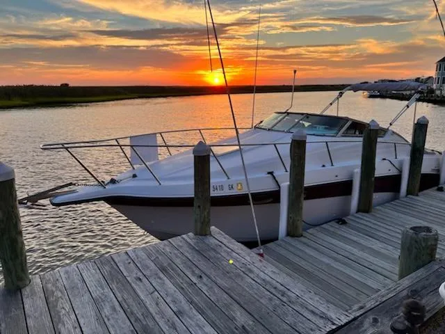 The Image of 1997 Crownline 250 CR boat docked at sunset, serene waterfront view. - 0