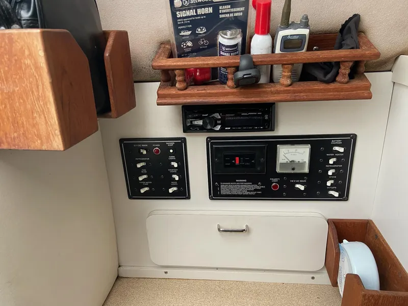 Slide: The Image of Control panel of a 1997 Crownline 250 CR boat with various switches and storage. - 12