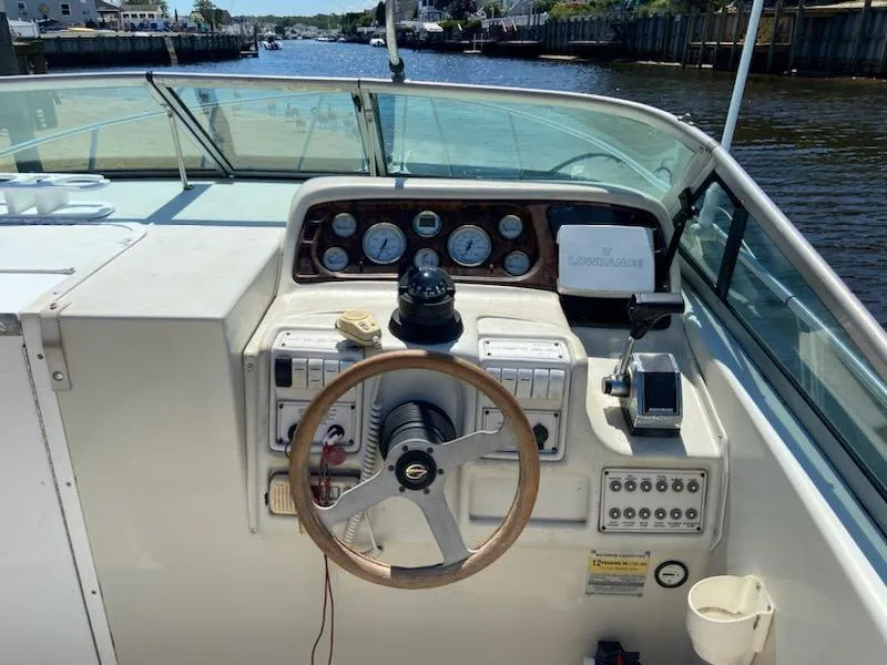 Slide: The Image of 1997 Crownline 250 CR boat dashboard with steering wheel and control panel. - 3
