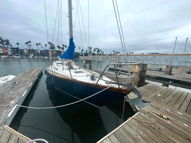 Slide: The Image of 1977 Van De Stadt Rebel 42 sailboat docked at a marina, overcast sky. - 14