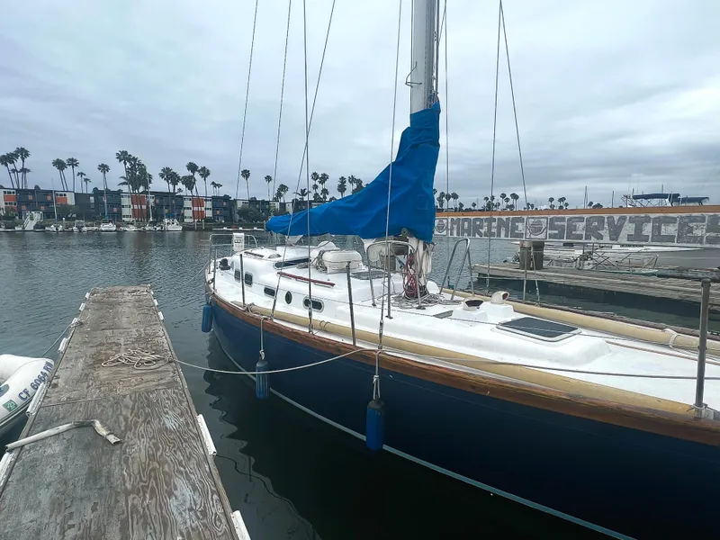 Slide: The Image of 1977 Van De Stadt Rebel 42 sailboat docked in a marina with overcast skies. - 15