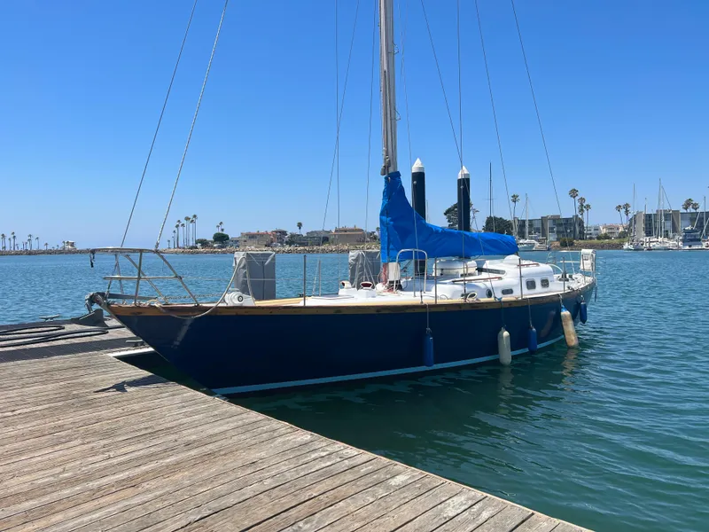 Slide: The Image of 1977 Van De Stadt Rebel 42 sailboat docked in a sunny marina. - 2