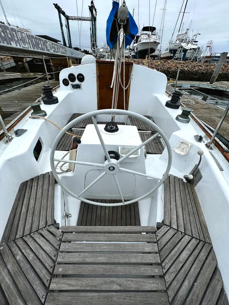 Slide: The Image of 1977 Van De Stadt Rebel 42 sailboat cockpit with wooden deck and steering wheel. - 22