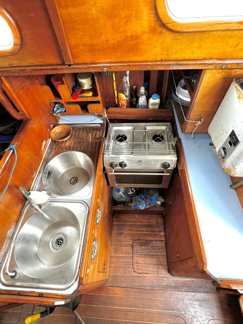 Slide: The Image of 1977 Van De Stadt Rebel 42 yacht kitchen with dual sinks and stove. - 33