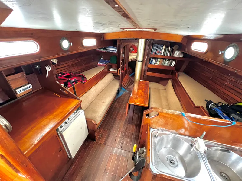 Slide: The Image of 1977 Van De Stadt Rebel 42 yacht interior with wooden furnishings and compact kitchen area. - 34