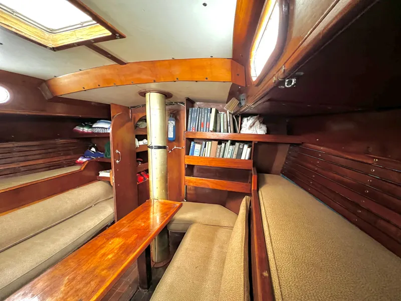 Slide: The Image of Interior of 1977 Van De Stadt Rebel 42 sailboat with wooden furnishings and cozy seating. - 35