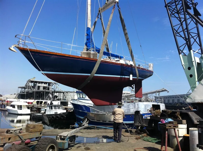Slide: The Image of 1977 Van De Stadt Rebel 42 sailboat being lifted at a marina. - 5