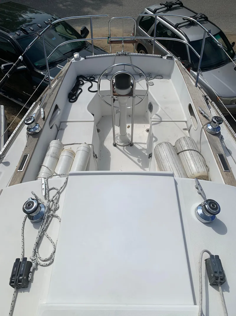 Slide: The Image of 1979 Sabre 28-2 sailboat deck with steering wheel and winches. - 13