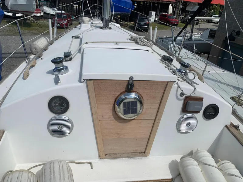 Slide: The Image of 1979 Sabre 28-2 sailboat deck with wooden hatch and nautical equipment. - 14