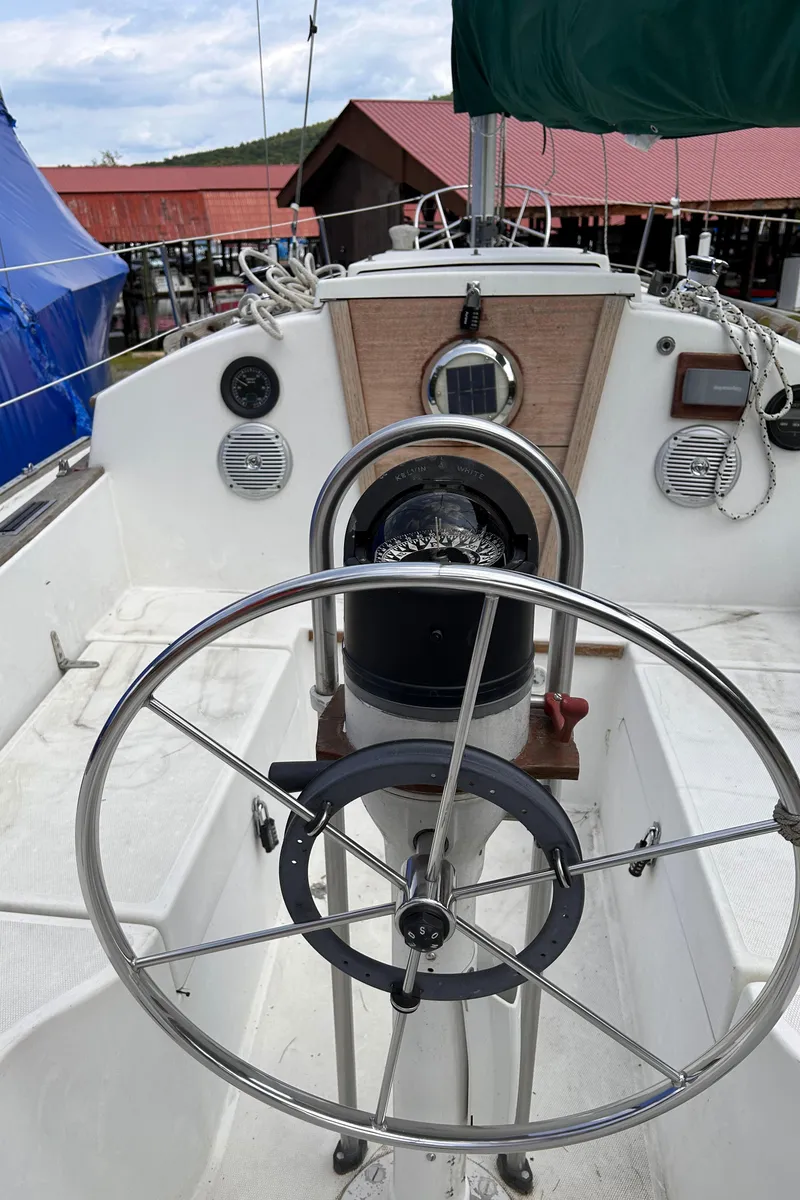 Slide: The Image of 1979 Sabre 28-2 sailboat cockpit with steering wheel and navigation instruments. - 16