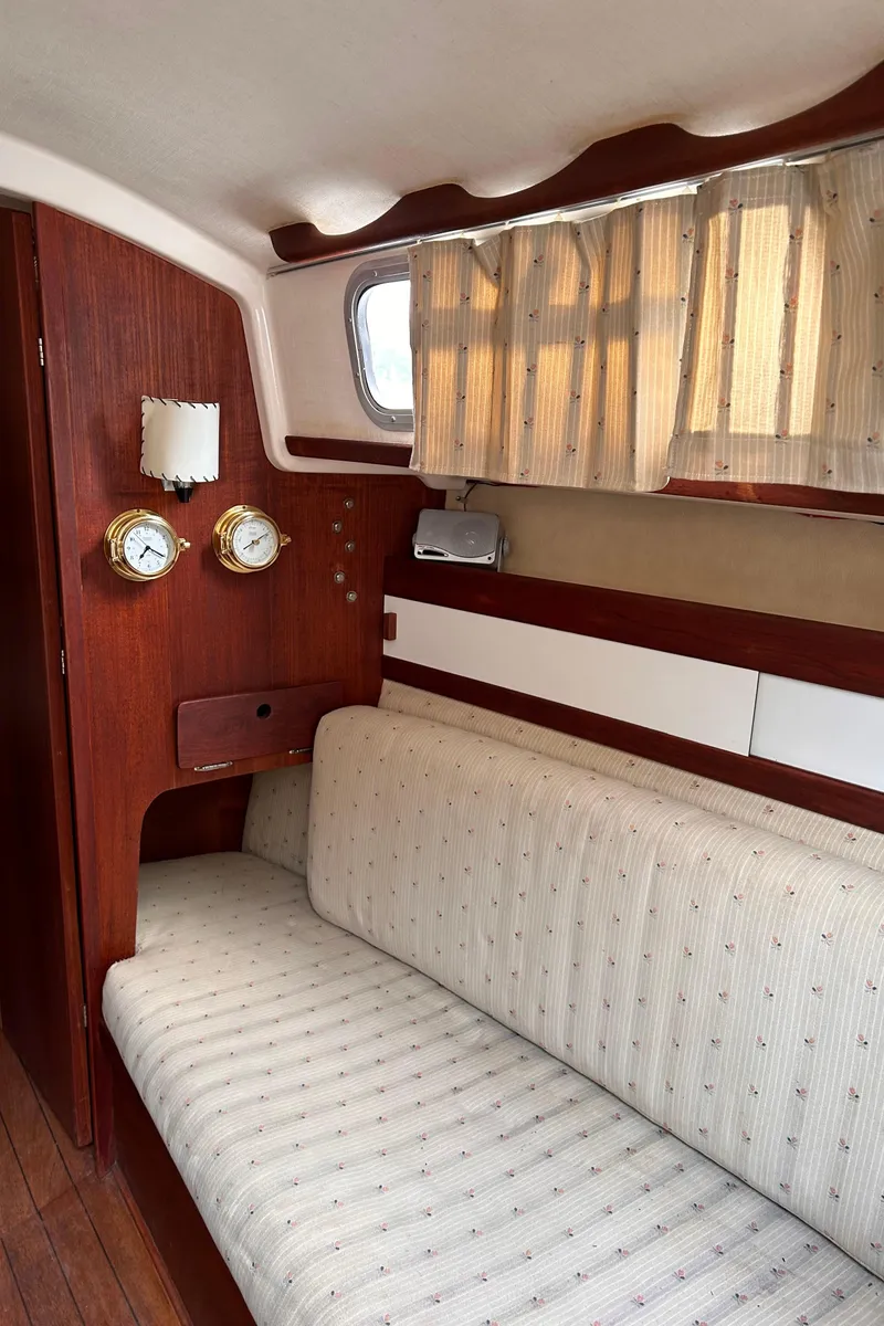 Slide: The Image of Interior of a 1979 Sabre 28-2 sailboat with wooden paneling and cushioned seating. - 21