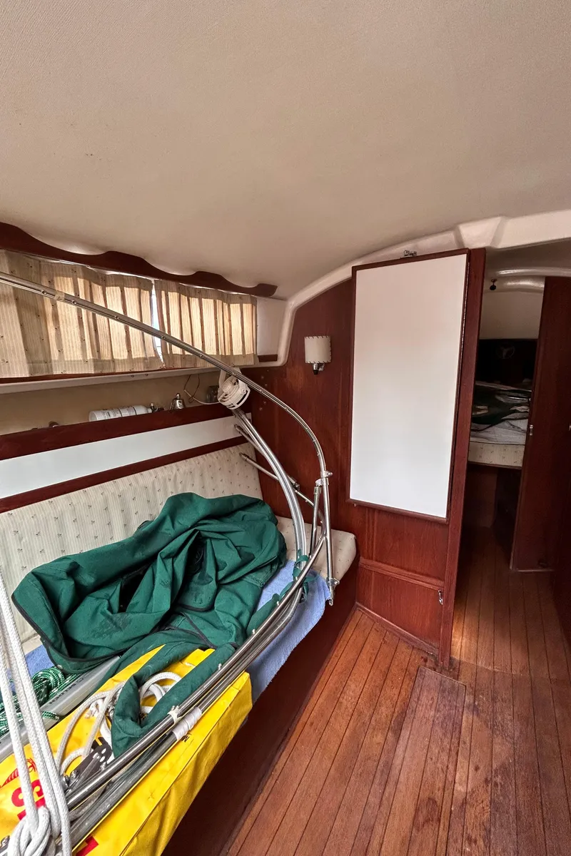 Slide: The Image of Interior of a 1979 Sabre 28-2 sailboat with wooden flooring and storage. - 26