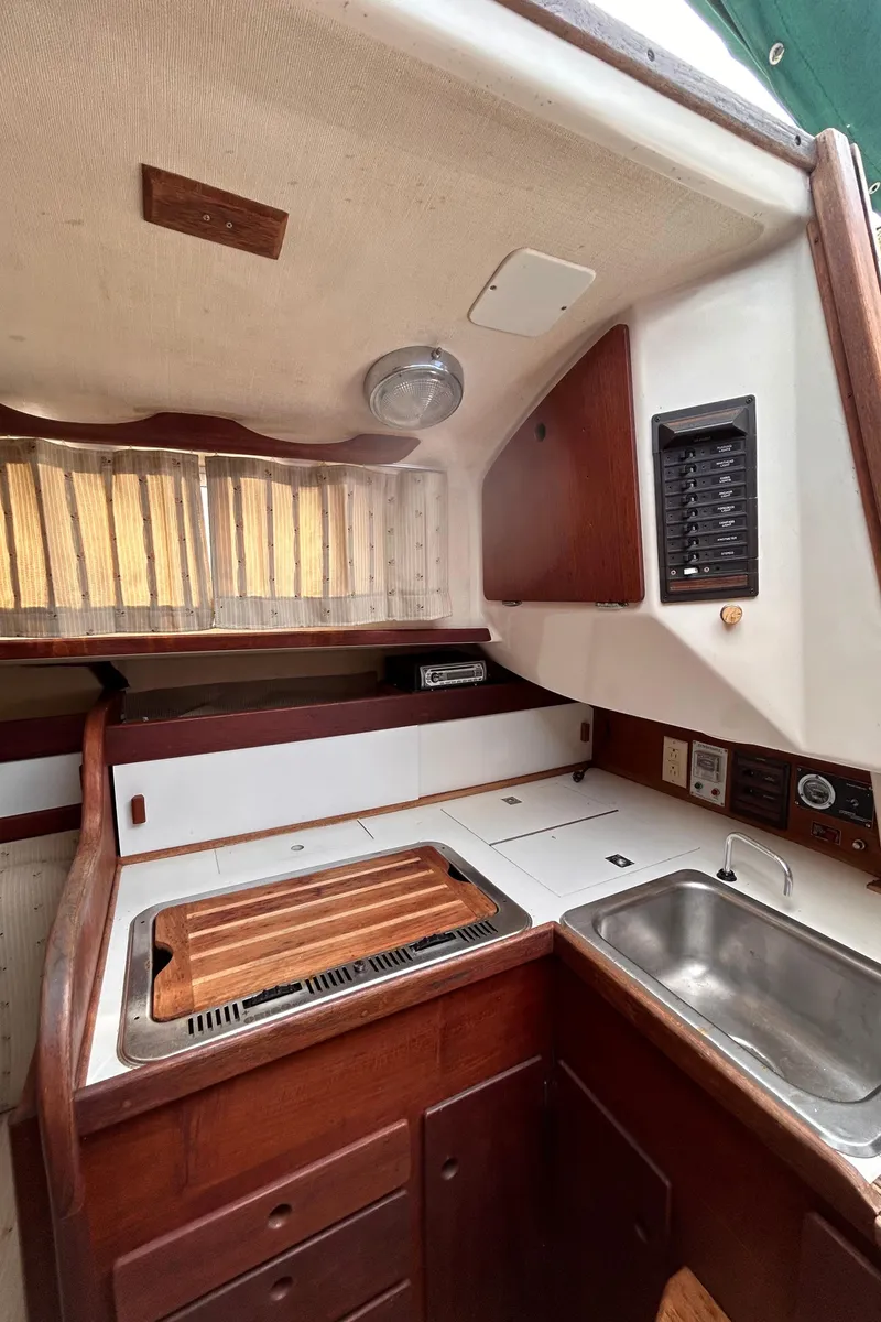 Slide: The Image of 1979 Sabre 28-2 sailboat galley with wood cabinetry and sink. - 27
