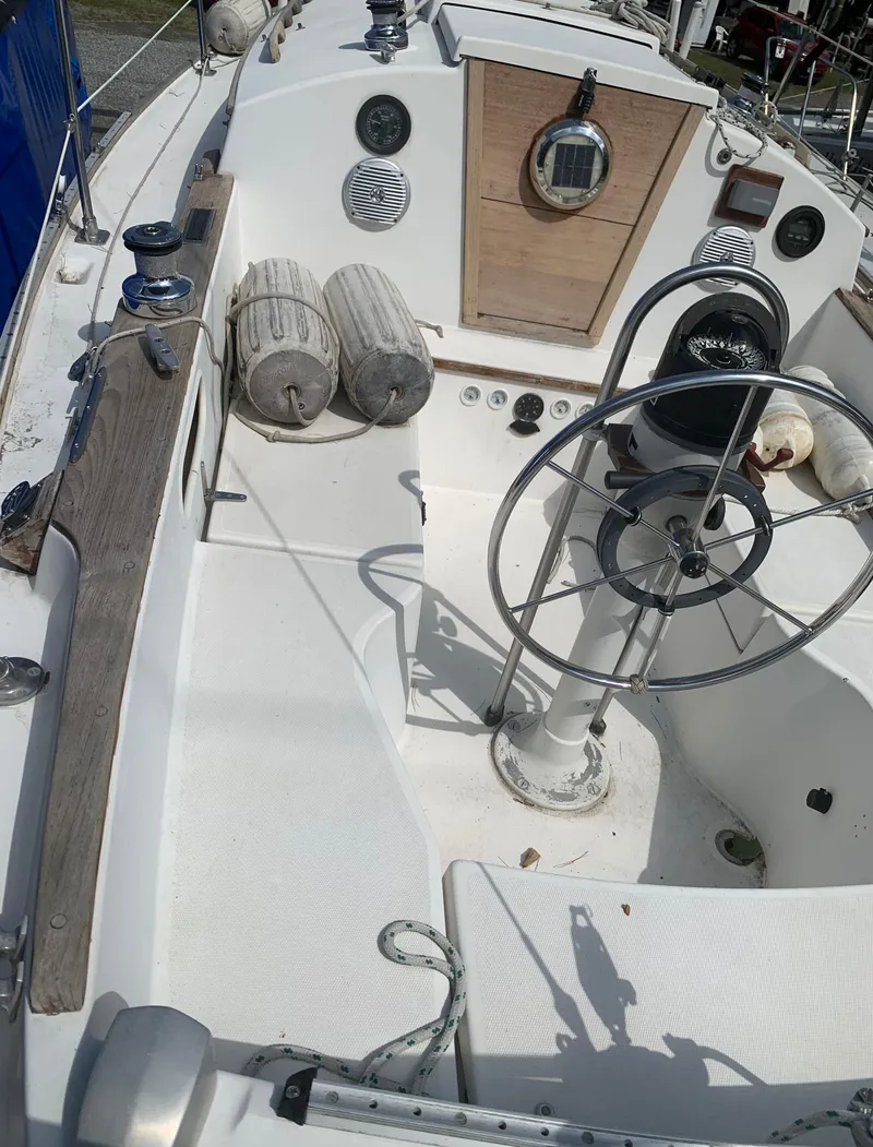 Slide: The Image of 1979 Sabre 28-2 sailboat cockpit with steering wheel and nautical equipment. - 6