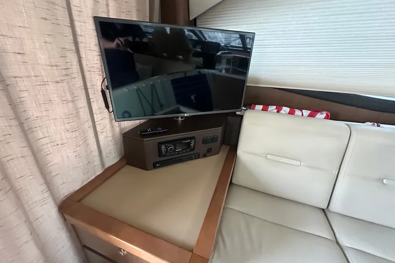 Slide: The Image of Interior of 2017 Sea Ray Sundancer 400 with TV and beige seating area. - 67