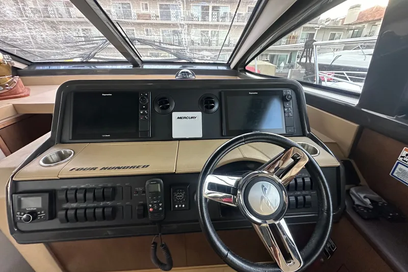 Slide: The Image of Helm of 2017 Sea Ray Sundancer 400 with dual displays and modern controls. - 68
