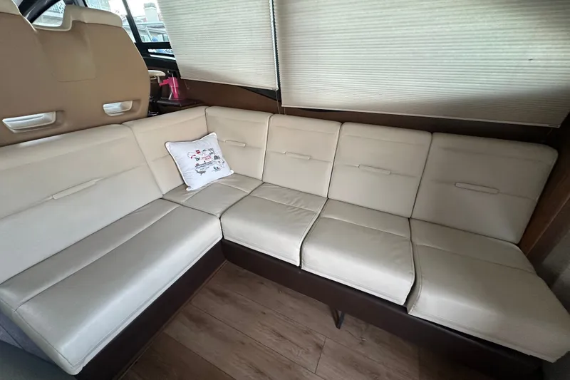 Slide: The Image of Interior of 2017 Sea Ray Sundancer 400 with beige leather seating and decorative pillow. - 45