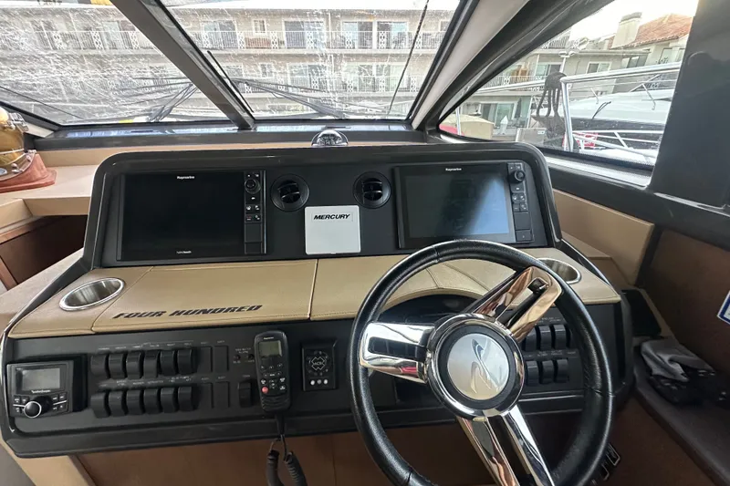 Slide: The Image of Interior helm of 2017 Sea Ray Sundancer 400 yacht with steering wheel and navigation screens. - 53