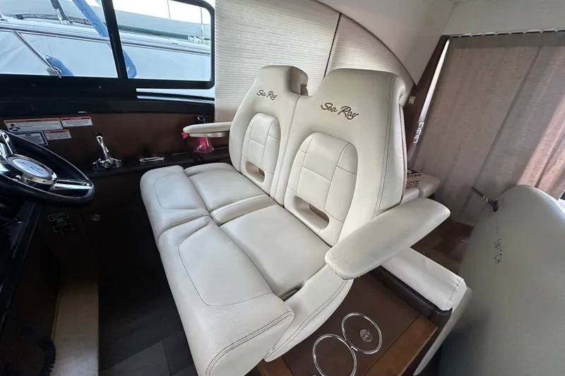 Slide: The Image of 2017 Sea Ray Sundancer 400 interior with plush white seating and steering wheel. - 50