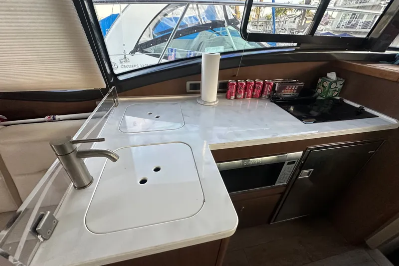 Slide: The Image of 2017 Sea Ray Sundancer 400 yacht kitchen with sink, stove, and countertop accessories. - 52