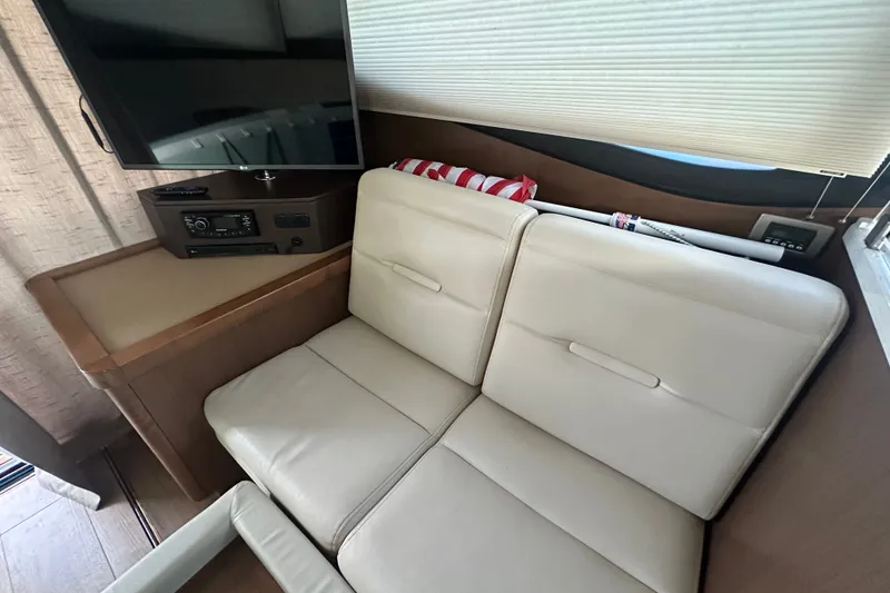 Slide: The Image of Interior of 2017 Sea Ray Sundancer 400 yacht with beige seating and entertainment system. - 51