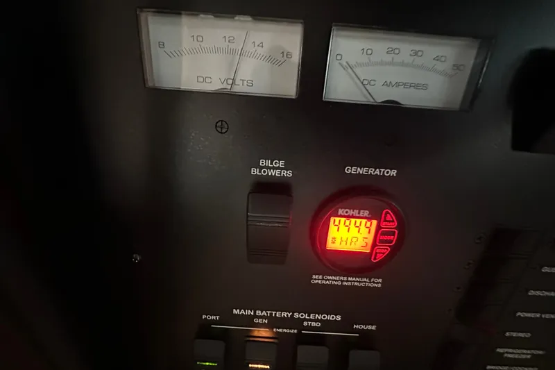Slide: The Image of Control panel of a 2017 Sea Ray Sundancer 400 boat, featuring gauges and generator display. - 71