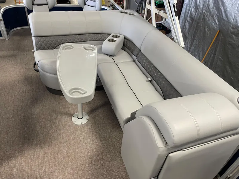 Slide: The Image of Luxurious seating area in 2020 Ranger 220FC boat with table and cup holders. - 11