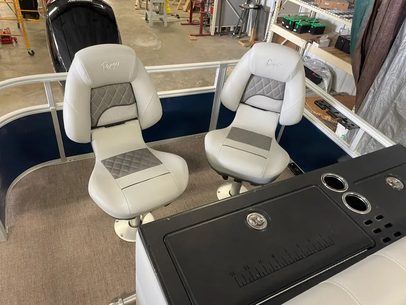 Slide: The Image of 2020 Ranger 220FC boat interior with two cushioned seats and a control panel. - 13