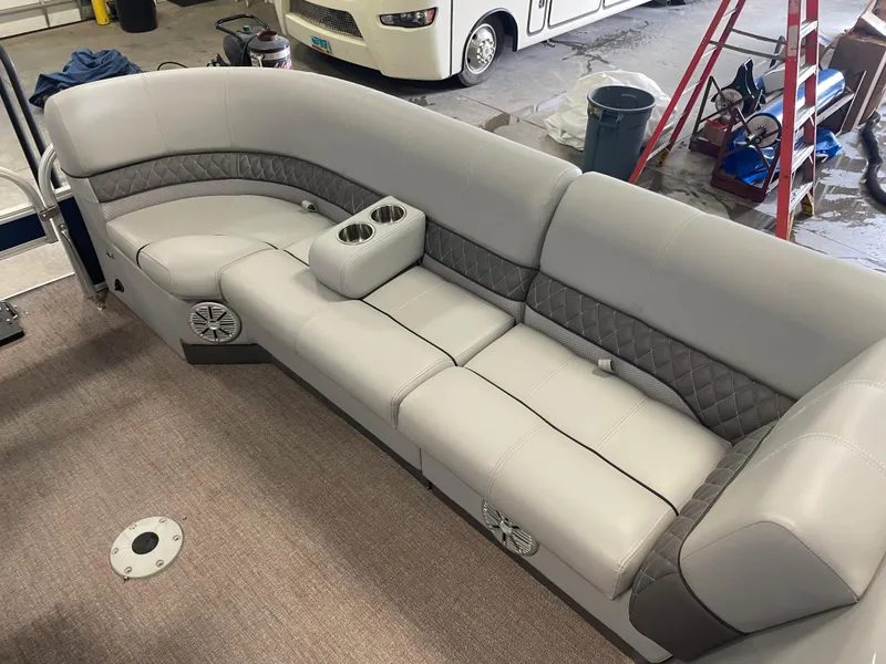 Slide: The Image of Luxurious seating on 2020 Ranger 220FC boat, featuring gray upholstery and built-in cup holders. - 6