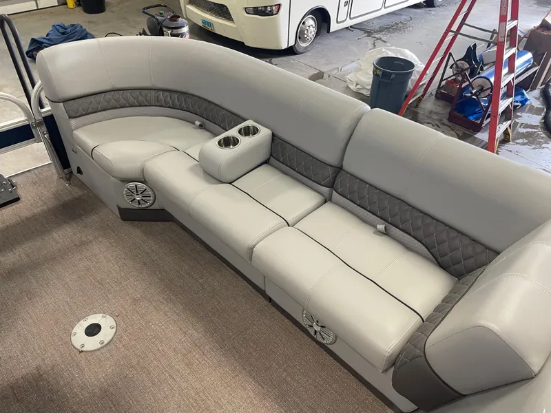 Slide: The Image of 2020 Ranger 220FC boat interior with gray cushioned seating and cup holders. - 7