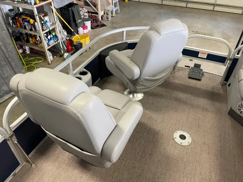 Slide: The Image of Two gray seats on a 2020 Ranger 220FC boat in a garage setting. - 8