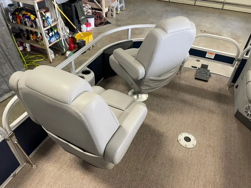 Slide: The Image of 2020 Ranger 220FC boat interior with two gray seats and carpeted flooring. - 9