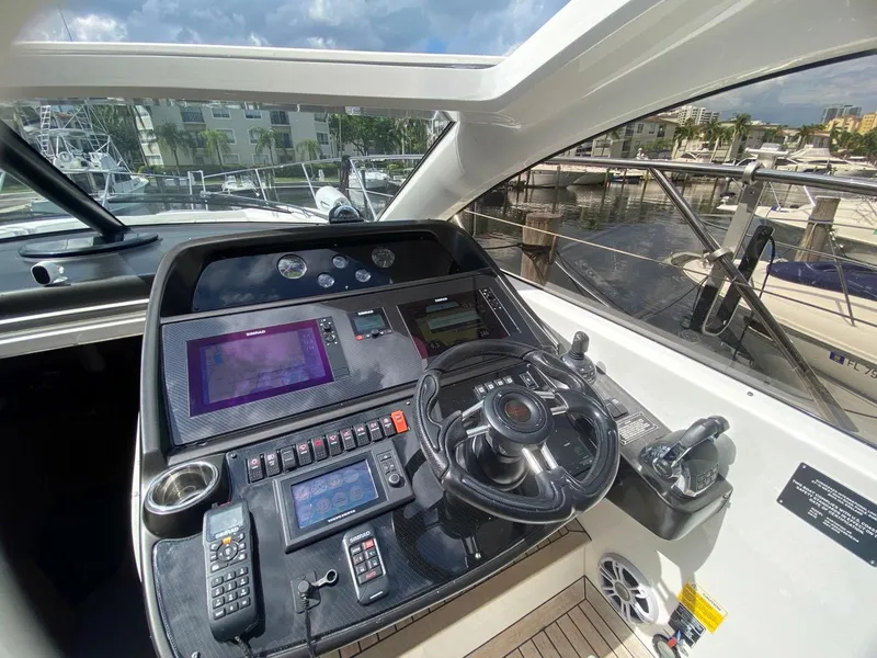 Slide: The Image of Sunseeker 48 Portofino XPS 2014 yacht helm with modern navigation controls and marina view. - 10