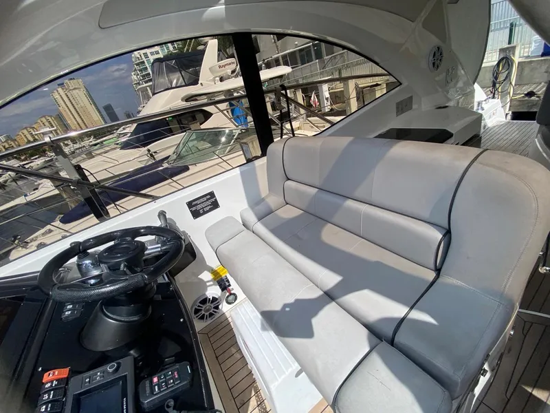 Slide: The Image of Interior of 2014 Sunseeker 48 Portofino XPS yacht with plush seating and steering wheel. - 12