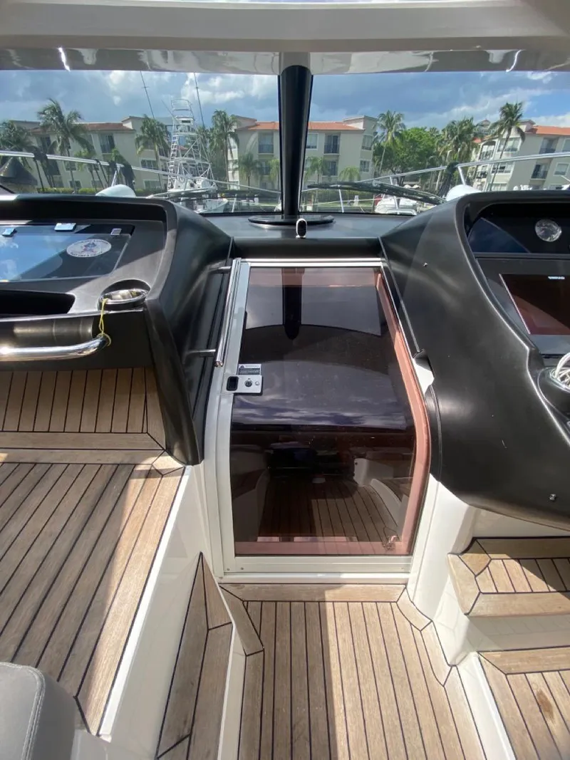 Slide: The Image of 2014 Sunseeker 48 Portofino XPS yacht cockpit with sleek design and wooden flooring. - 29