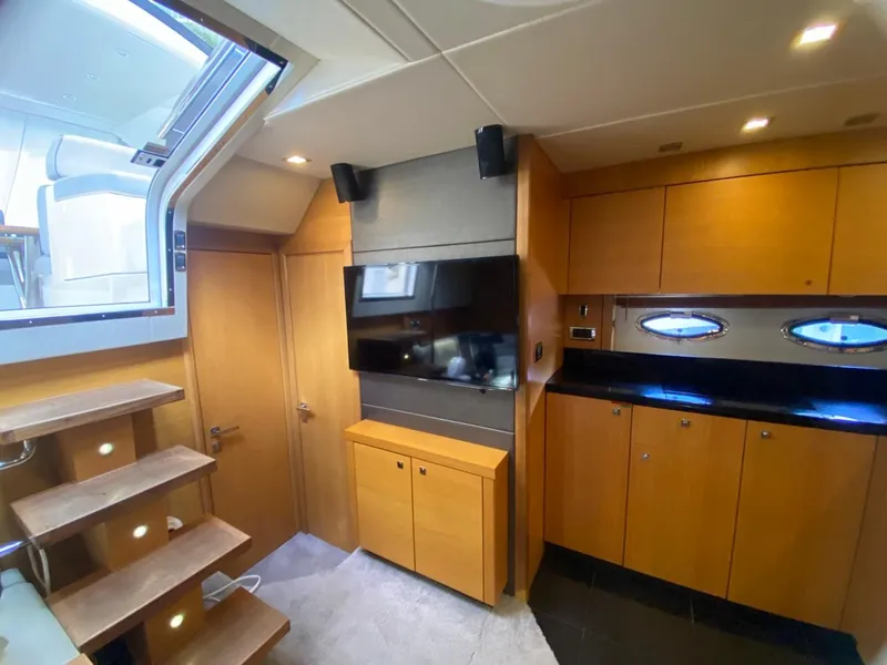 Slide: The Image of Interior of 2014 Sunseeker 48 Portofino XPS yacht with modern wood cabinetry and TV. - 32