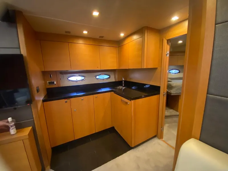 Slide: The Image of Luxurious 2014 Sunseeker 48 Portofino XPS yacht interior kitchen with wood cabinetry. - 37