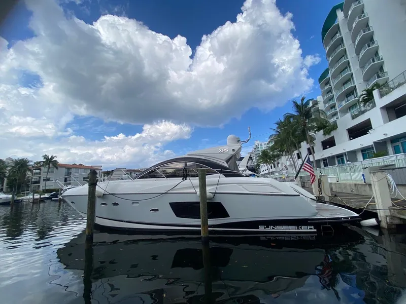 Slide: The Image of 2014 Sunseeker 48 Portofino XPS yacht docked by waterfront buildings. - 4