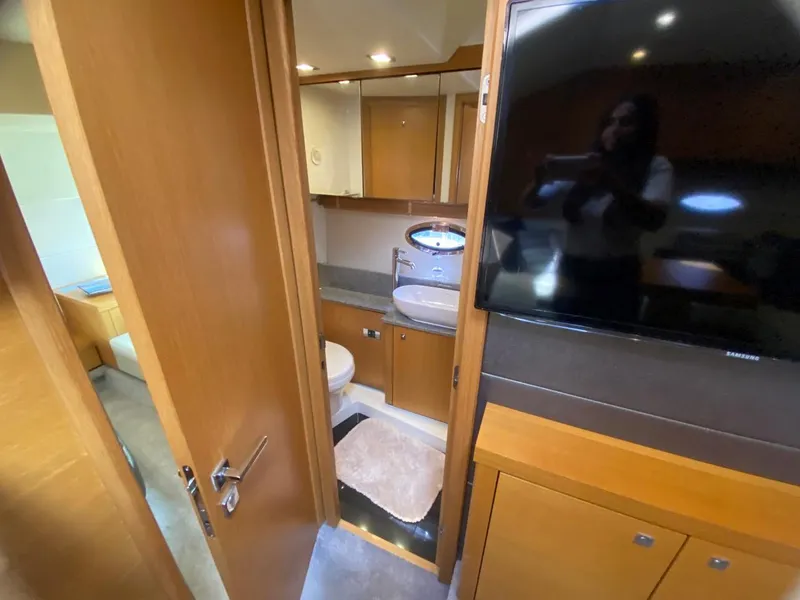 Slide: The Image of Interior of 2014 Sunseeker 48 Portofino XPS yacht, featuring bathroom and modern wood cabinetry. - 46