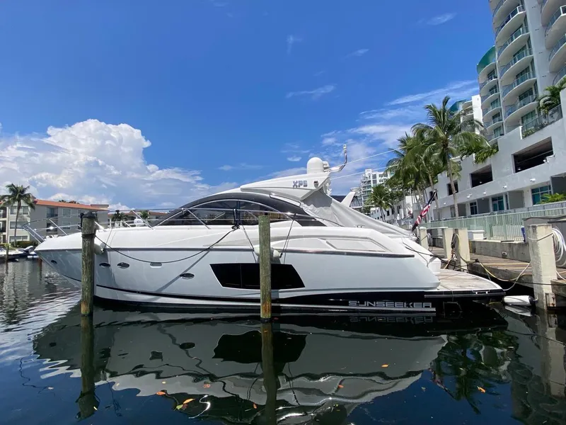 Slide: The Image of 2014 Sunseeker 48 Portofino XPS yacht docked by waterfront buildings. - 5