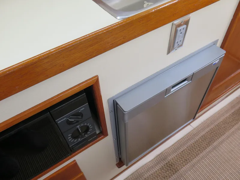 Slide: The Image of 1988 Blackman 26 Billfisher interior with wood trim, sink, and built-in appliances. - 12