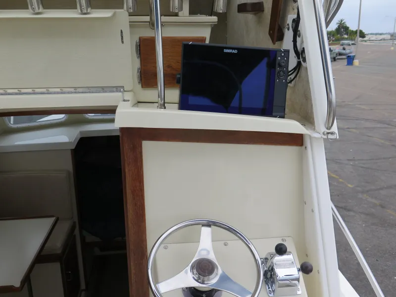 Slide: The Image of 1988 Blackman 26 Billfisher boat helm with steering wheel and navigation display. - 15